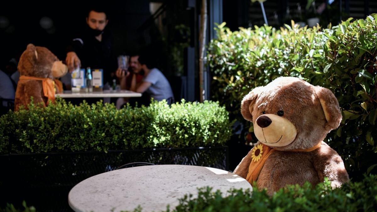 A large teddy bear, used to enforce social distancing, is pictured sitting at a cafe in Pristina, as Kosovo authorities announce new measures to fight against the resurgence of the Covid-19, the novel coronavirus. Photo: AFP