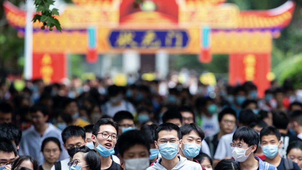 Students leave a testing site for China's national college entrance examinations, also known as the gaokao, in Nanjing in eastern China's Jiangsu Province. Almost 11 million students began taking China's university entrance exam Tuesday after a delay as the country worked to bring down coronavirus infections. Photo: AP