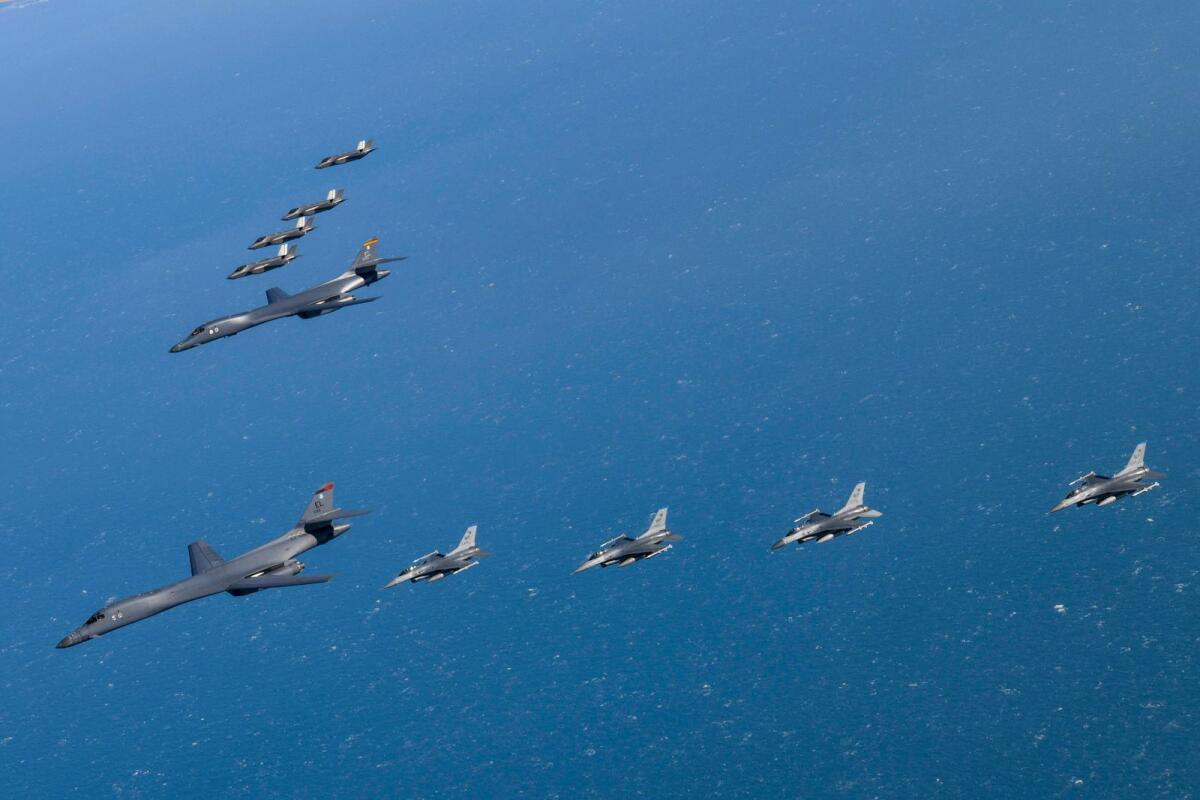 US Air Force B-1B bombers, centre, fly in formation with South Korea's Air Force F-35A fighter jets, top, and US Air Force F-16 fighter jets, bottom, over the South Korea Peninsula during a joint air drill in South Korea on Sunday. — AP