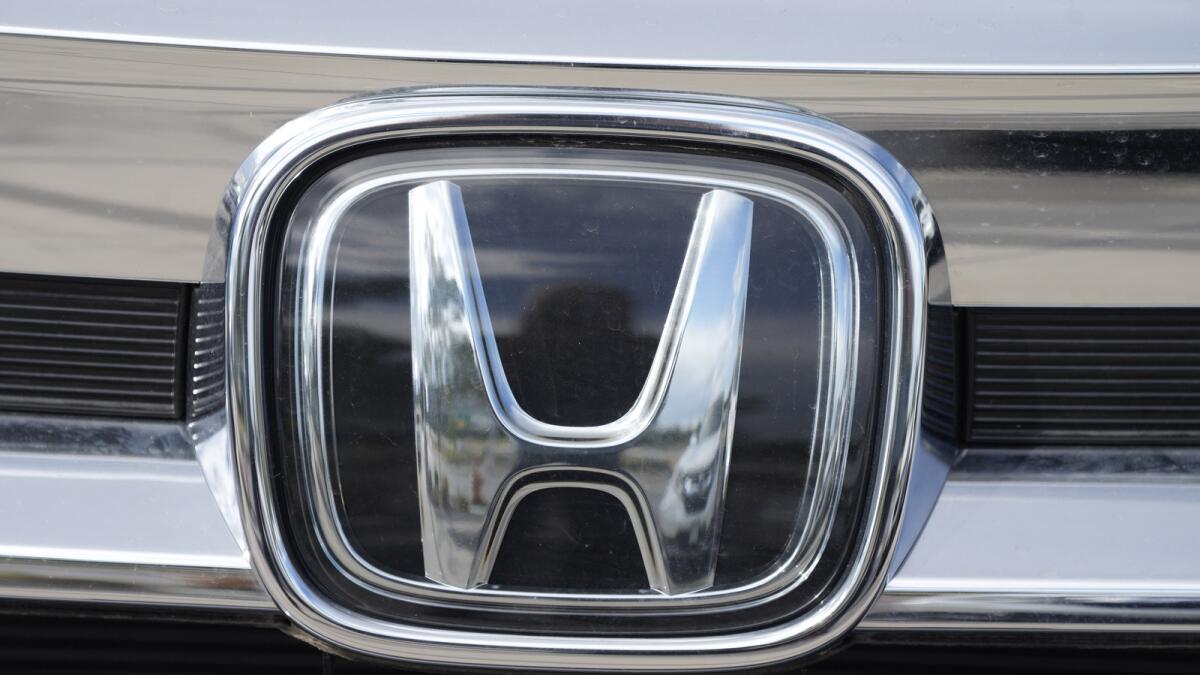 The Honda company logo is shown outside a Honda dealership Sunday, Sept. 12, 2021, in Highlands Ranch, Colorado. — AP file