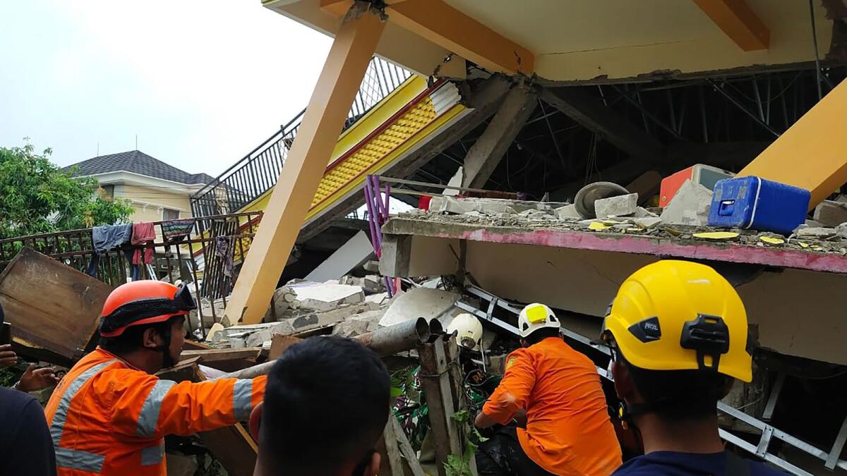 Rescuers looking for survivors trapped in a collapsed building in Mamuju, after a 6.2-magnitude earthquake rocked Sulawesi island. AFP