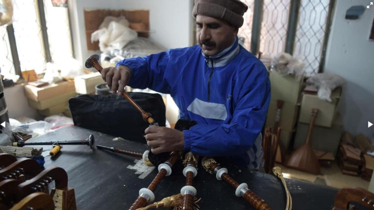 A worker in Pakistan works on the bagpipes.