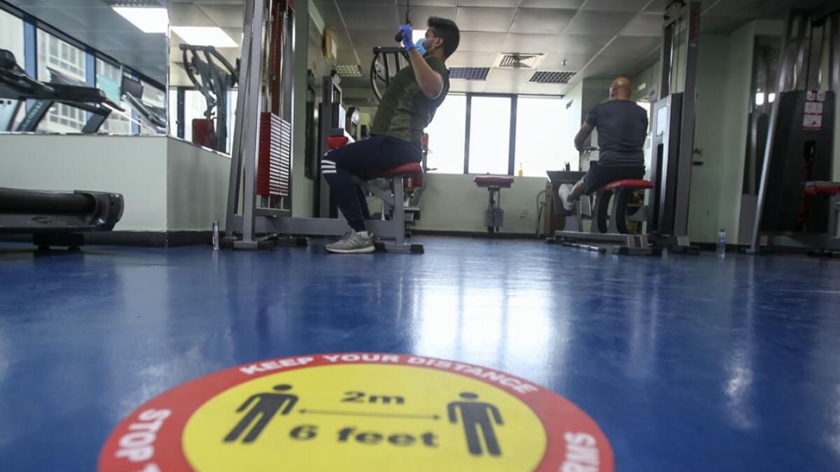 Safety stickers placed on the floor of a gym in Abu Dhabi reminding residents to maintain safe distance while doing the workout. Photo: Ryan Lim/Khaleej Times