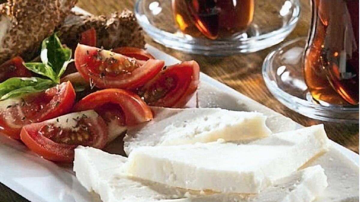 Simit, cheese and tomatoes accompanied by tea, classic teapot.an indispensable drink of the Turkish cuisine