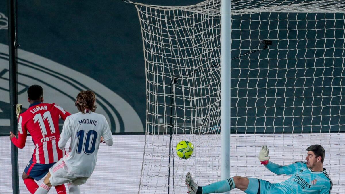 Atletico Madrid's Thomas Lemar (left) tries a shot during the Spanish La Liga  match against Real Madrid. — AP