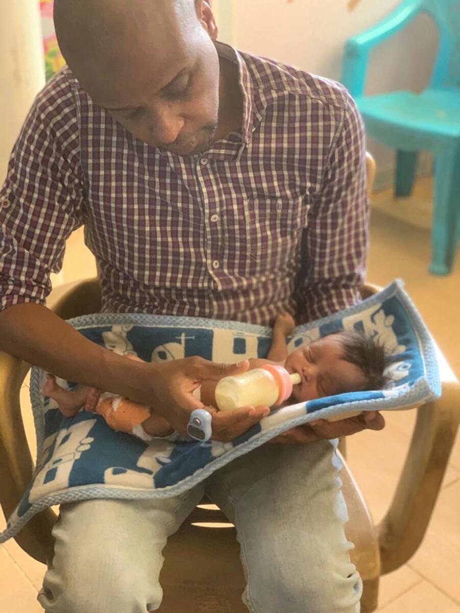 Dr  Abdallah Kenany feeds a newborn baby, who died a few days later, in Khartoum, Sudan, in this handout image released April 2023. — Reuers
