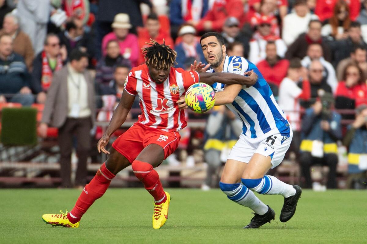 Almeria's El Bilal Toure (left) vies for the ball with Real Sociedad's Miker Merino. — AFP