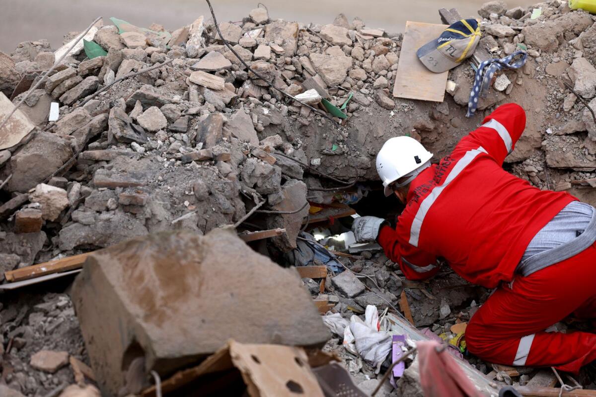 A worker looks through the rubble in the aftermath of a deadly earthquake in Talat N'Yaaqoub in Morocco on Tuesday. — Reuters