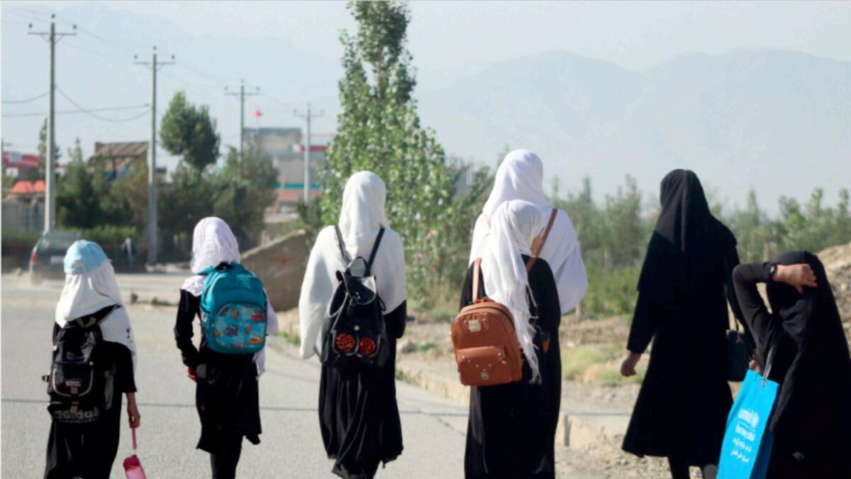 Girls walk to their school along a road in Gardez, Paktia porvince. — AFP