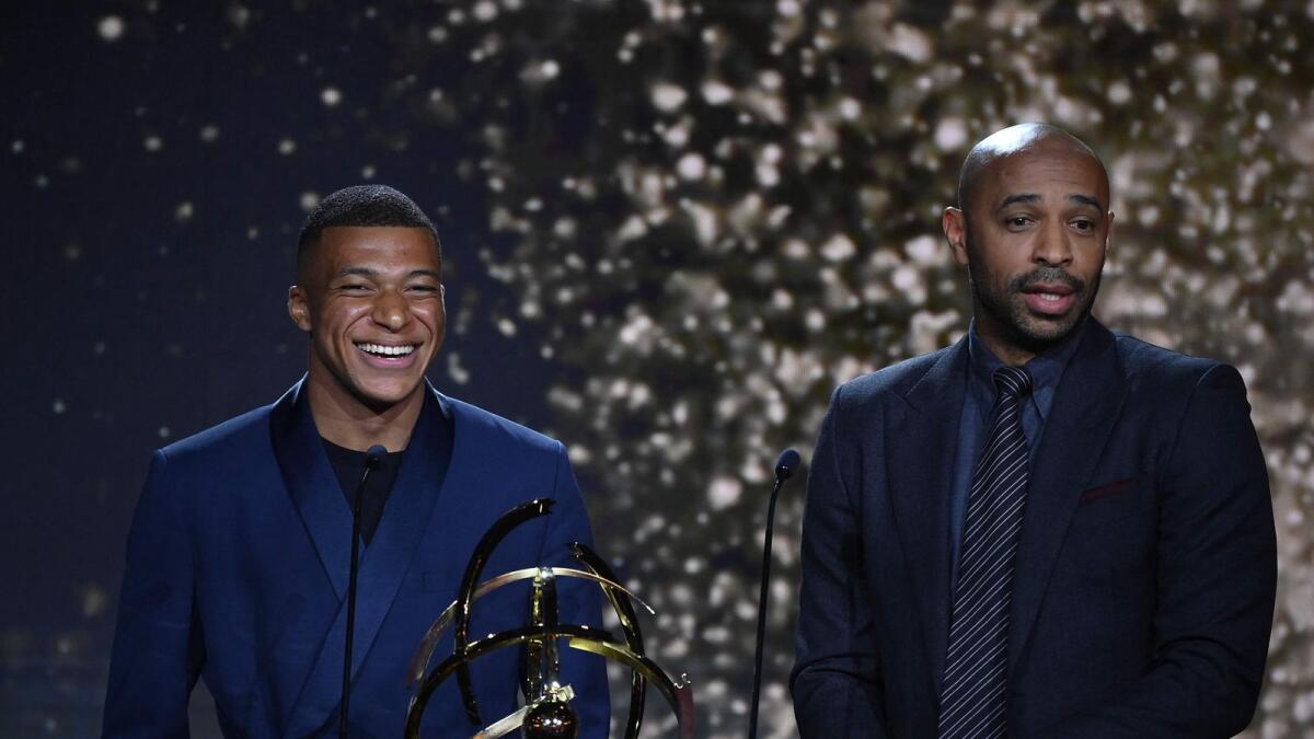 PSG star Kylian MBappe (left) with former player Thierry Henry after winning the French player of the year award. (AFP)
