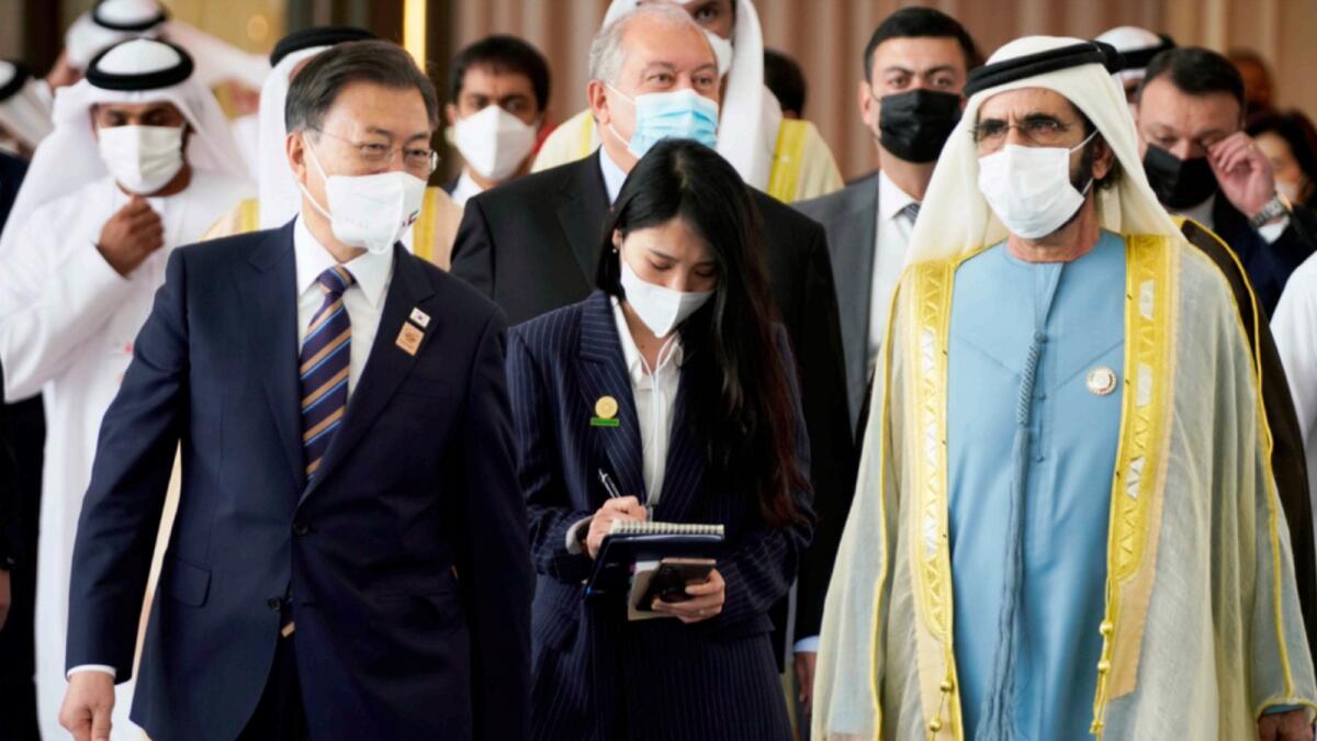 Sheikh Mohammed bin Rashid and South Korean President Moon Jae-in leave an event at Abu Dhabi Sustainability Week at Expo 2020 Dubai. — AP