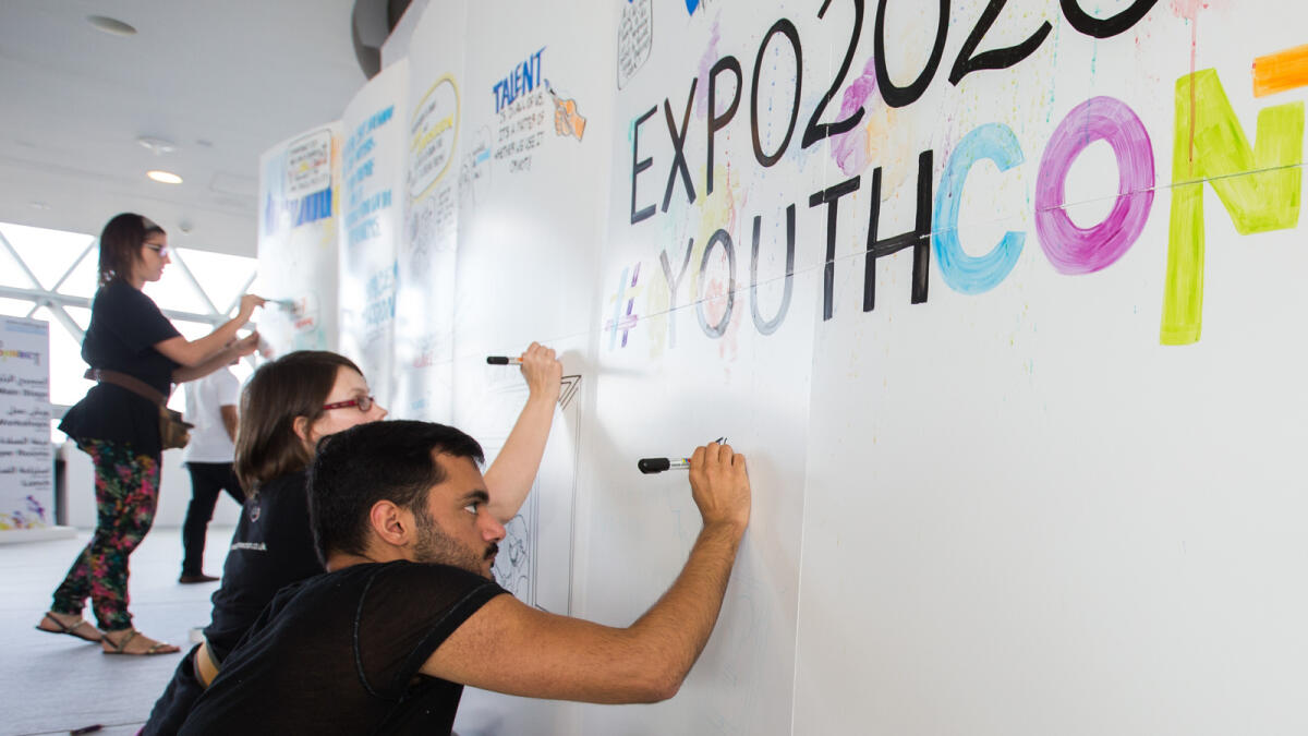 Artists painting the wall at the Youth Connect Forum at Meydan, Dubai, on Saturday.
