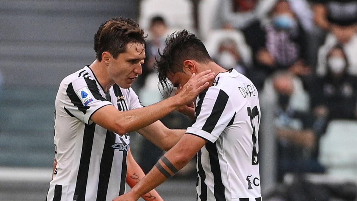 Juventus’ Paulo Dybala (right) is consoled by teammate Federico Chiesa as he leaves the pitch after suffering an injury during the game against Sampdoria on Sunday. —AP