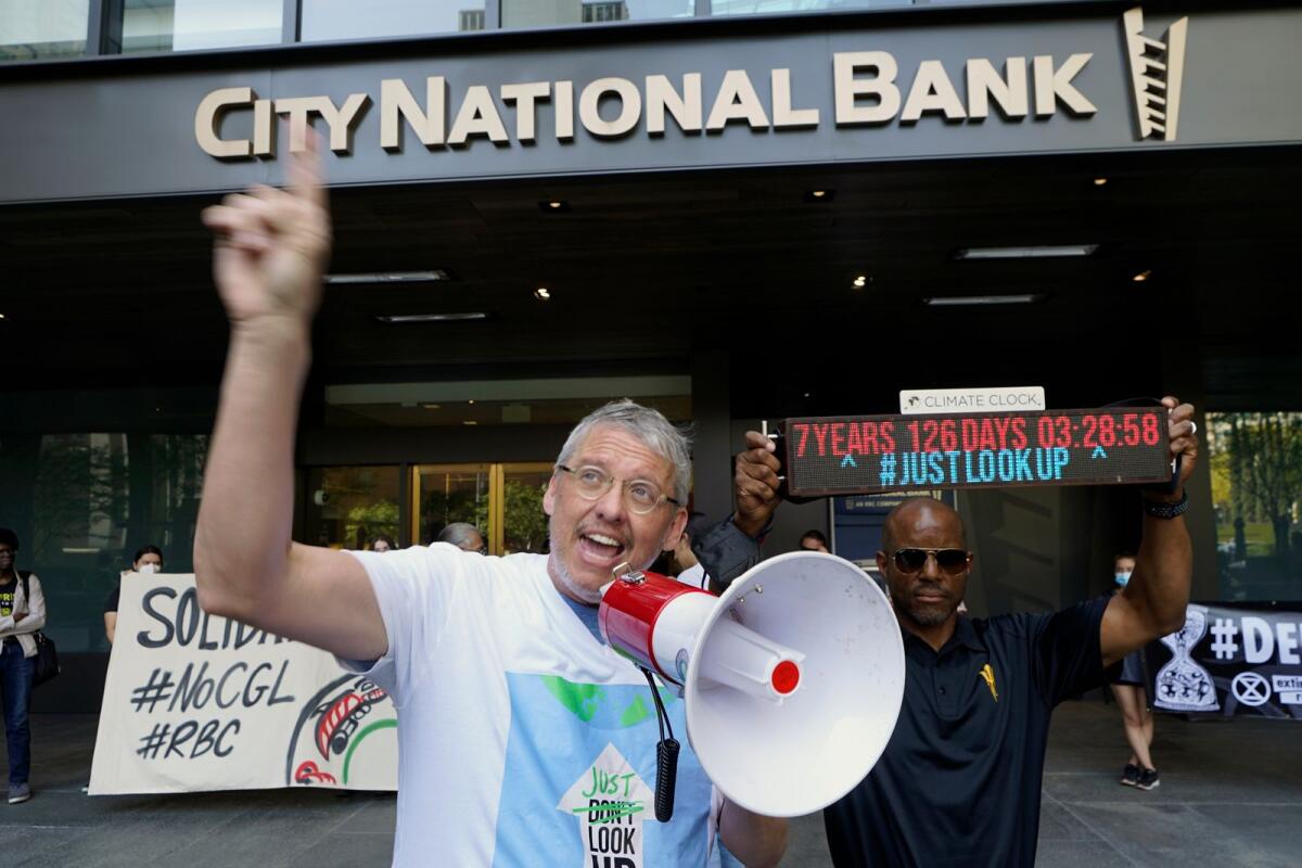Adam McKay joins members of the Youth Climate Los Angeles coalition and others protesting climate change outside City National Bank in Los Angeles, Friday, March 18, 2022. (Photo: AP)
