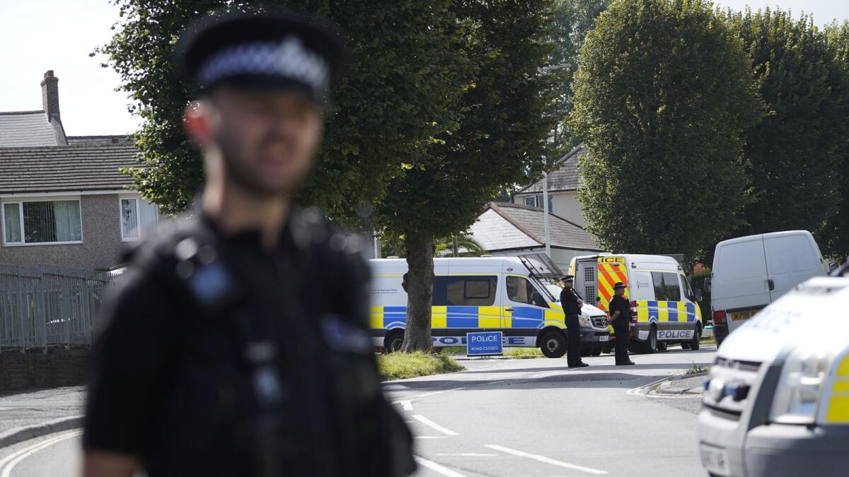 Police officers staff a cordon near the scene of a shooting incident in Plymouth, England. Photo: AFP