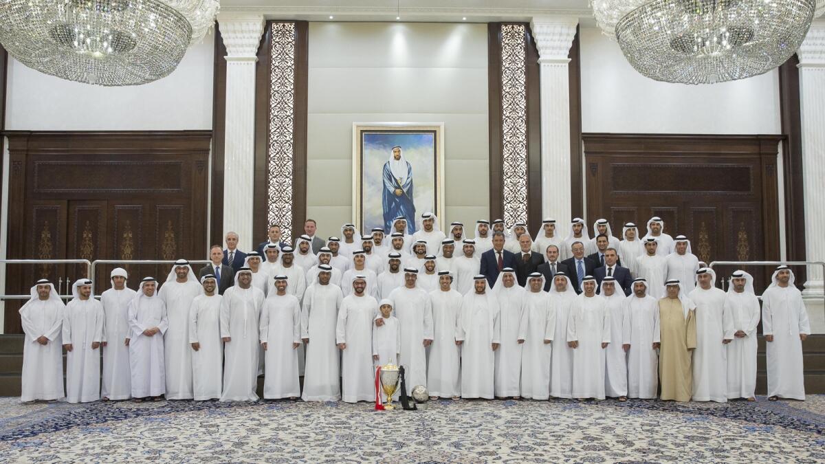 ABU DHABI, UNITED ARAB EMIRATES - June 20, 2016: HH Sheikh Hamdan bin Zayed Al Nahyan, Rulerâ??s Representative in the Western Region of Abu Dhabi (15th R), HH Sheikh Rashid bin Hamdan bin Zayed Al Nahyan (14th R), HH Sheikh Mohamed bin Zayed Al Nahyan, Crown Prince of Abu Dhabi and Deputy Supreme Commander of the UAE Armed Forces (13th R), HH Sheikh Mansour bin Zayed Al Nahyan, UAE Deputy Prime Minister and Minister of Presidential Affairs (12th R), and HH Sheikh Mohamed bin Butti Al Hamed (11th R), stand for a photograph with Al Jazira Football Club during an iftar reception at Al Bateen Palace.( Mohamed Al Hammadi / Crown Prince Court - Abu Dhabi )