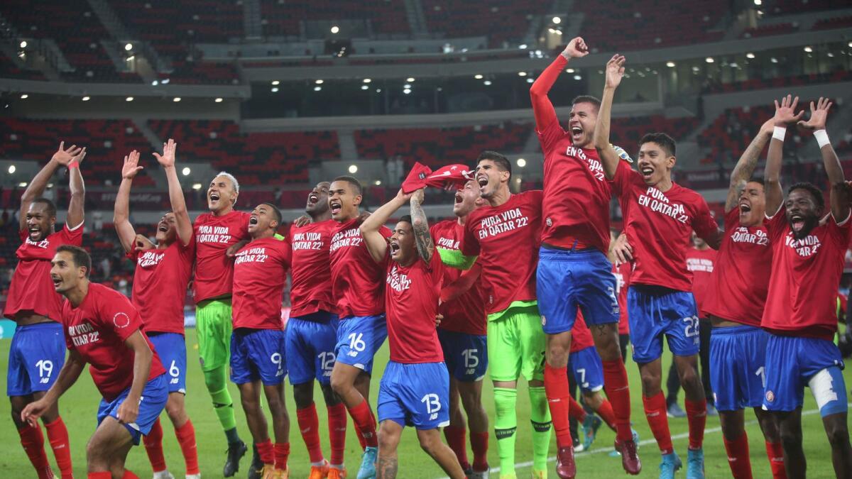 Costa Rican players celebrate after beating New Zealand on Tuesday. — AFP