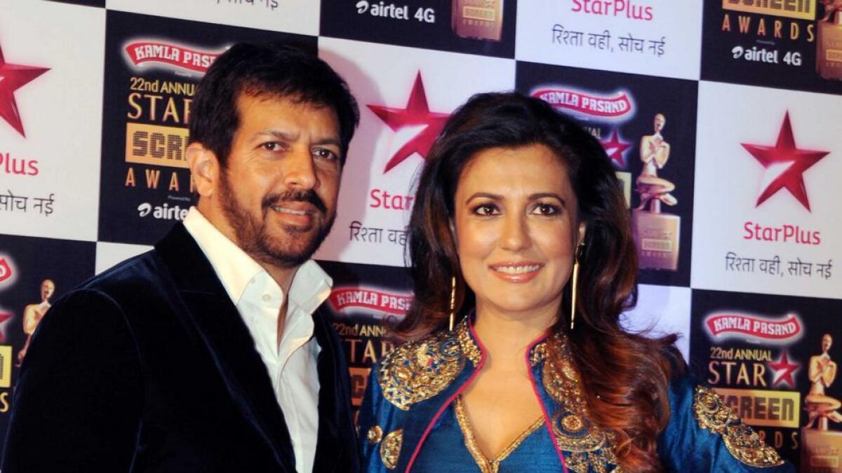 Indian Bollywood film director Kabir Khan (L) and his wife pose for a photograph during the Star Screen Awards 2016 ceremony in Mumbai. -AFP