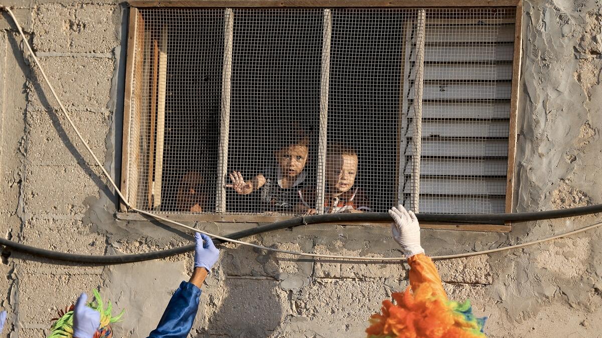 Clowns perform to entertain Palestinian children during a lockdown following the outbreak of the coronavirus disease (Covid-19), in Khan Younis in the southern Gaza Strip. Photo: Reuters
