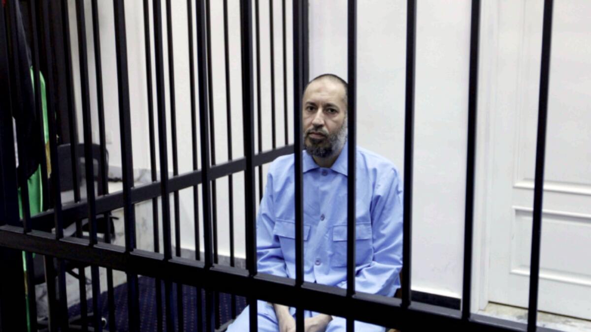 Saadi Gaddafi sits behind bars during a hearing at a courtroom in Tripoli in 2016. — Reuters file