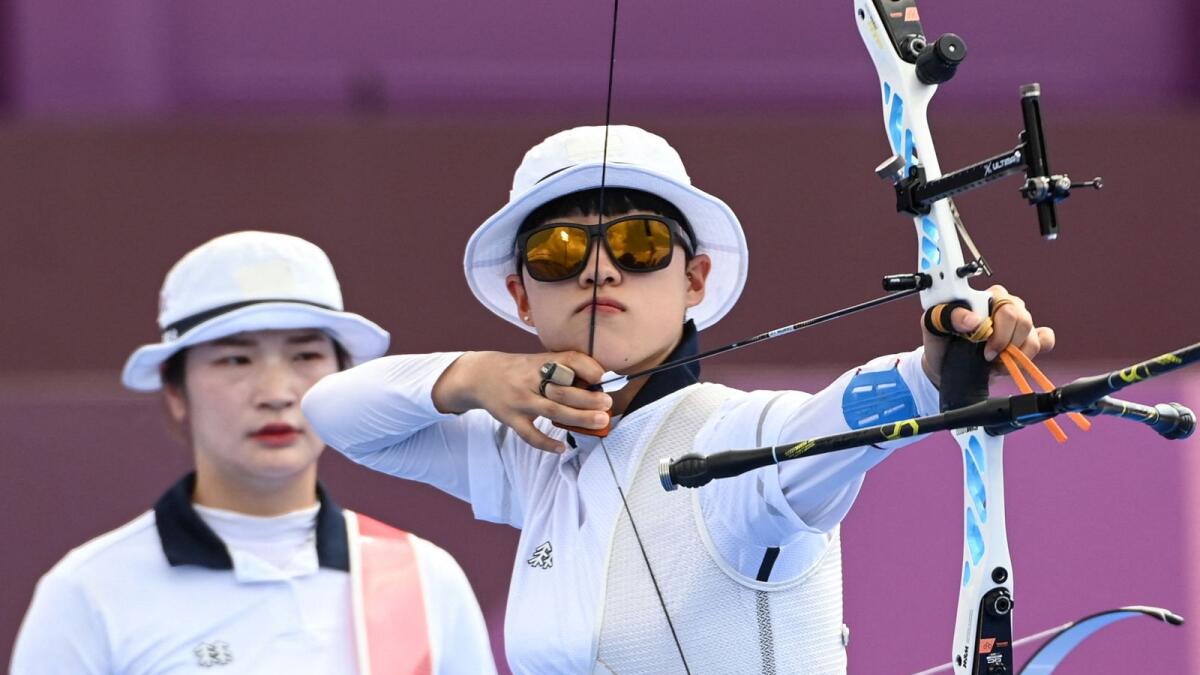 South Korea's An San (right) and Kang Chae-young compete in the women's team quarterfinals during the Tokyo 2020 Olympic Games at Yumenoshima Park Archery Field in Tokyo. — AFP
