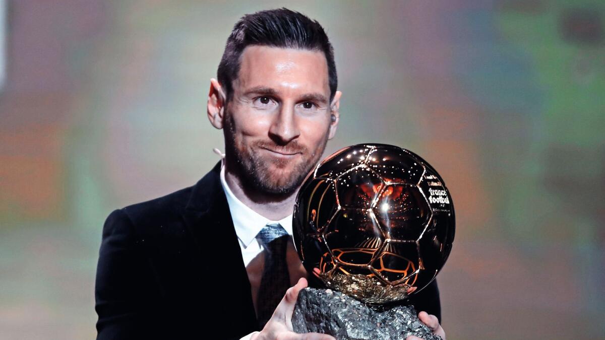 Lionel Messi with the Ballon d'Or. — AP file