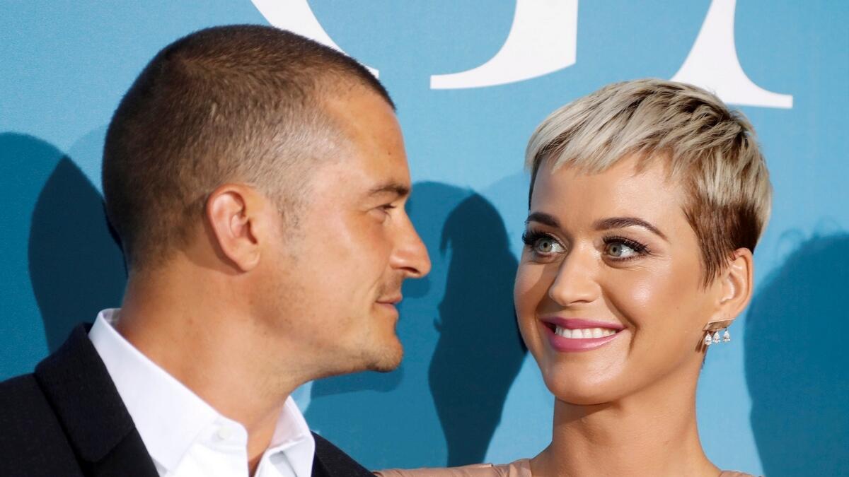 Singer Katy Perry and actor Orlando Bloom smile upon their arrival at an event.- Reuters file photo