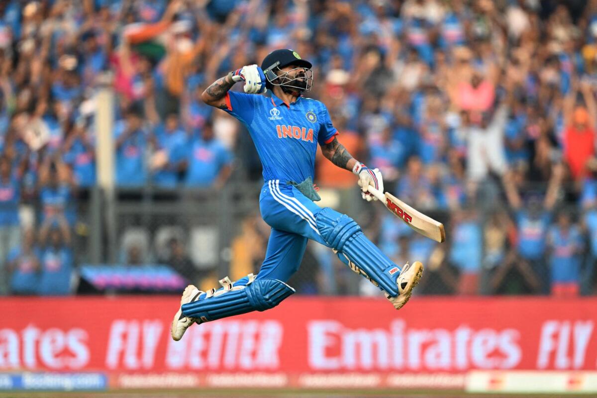 India's Virat Kohli celebrates after scoring a century (100 runs) during the 2023 ICC Men's Cricket World Cup. Photo: AFP