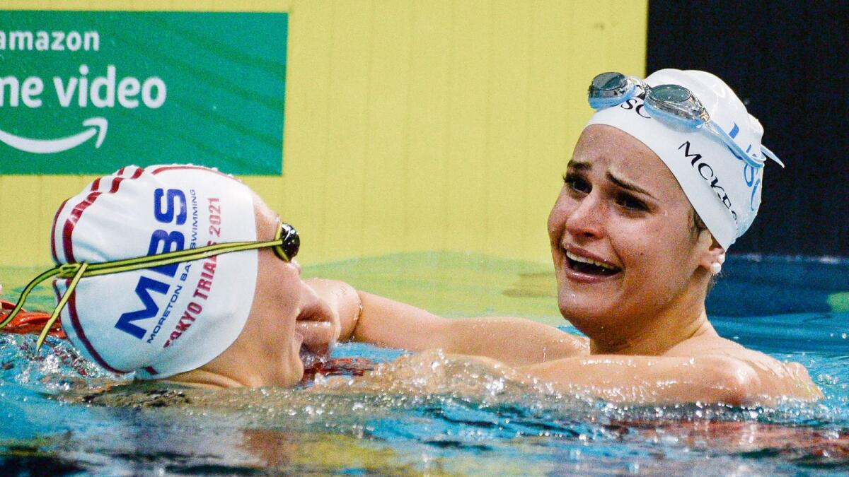 Kaylee McKeown (right) is congratulated by Minna Atherton after setting a new world record time in the women's 100m backstroke final during day two of the Australian Olympic swimming trials in Adelaide. — AFP