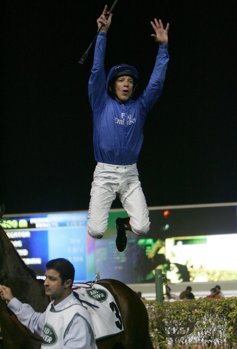 Frankie Dettori jumps off Delegator after winning the 1400m third race on the Dubai World Cup night in 2012. — KT file