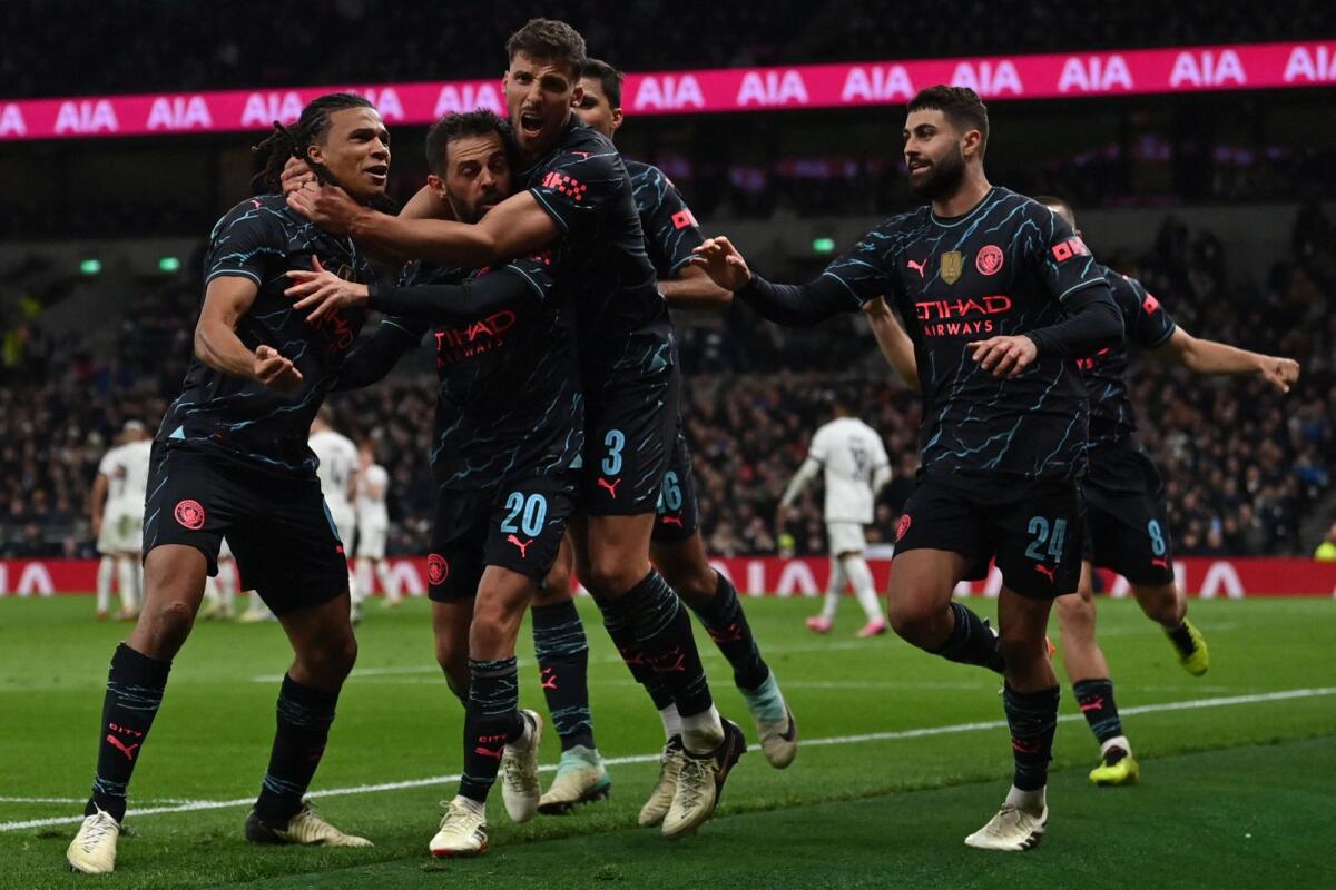 Manchester City's Dutch defender Nathan Ake (L) celebrates with teammates after scoring the opening goal of the English FA Cup fourth round football match against Tottenham Hotspur on Friday. - AFP