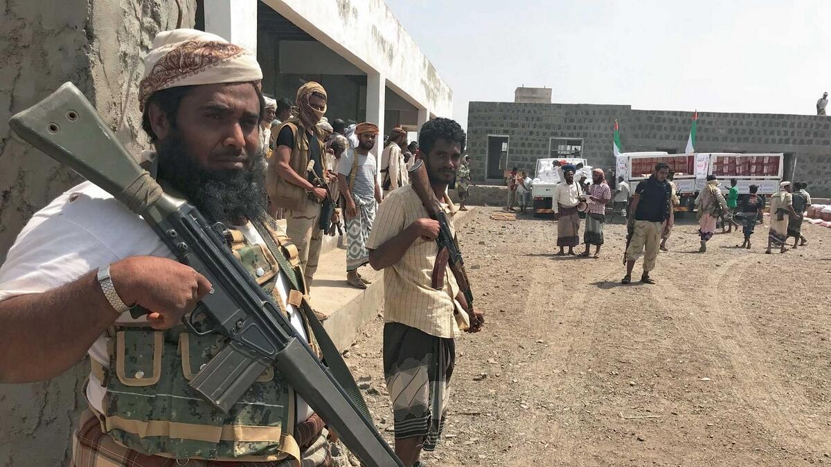 Yemeni fighters secure a building in Al Mokha where the UAE Red Crescent distributes aid to displaced people. — Reuters