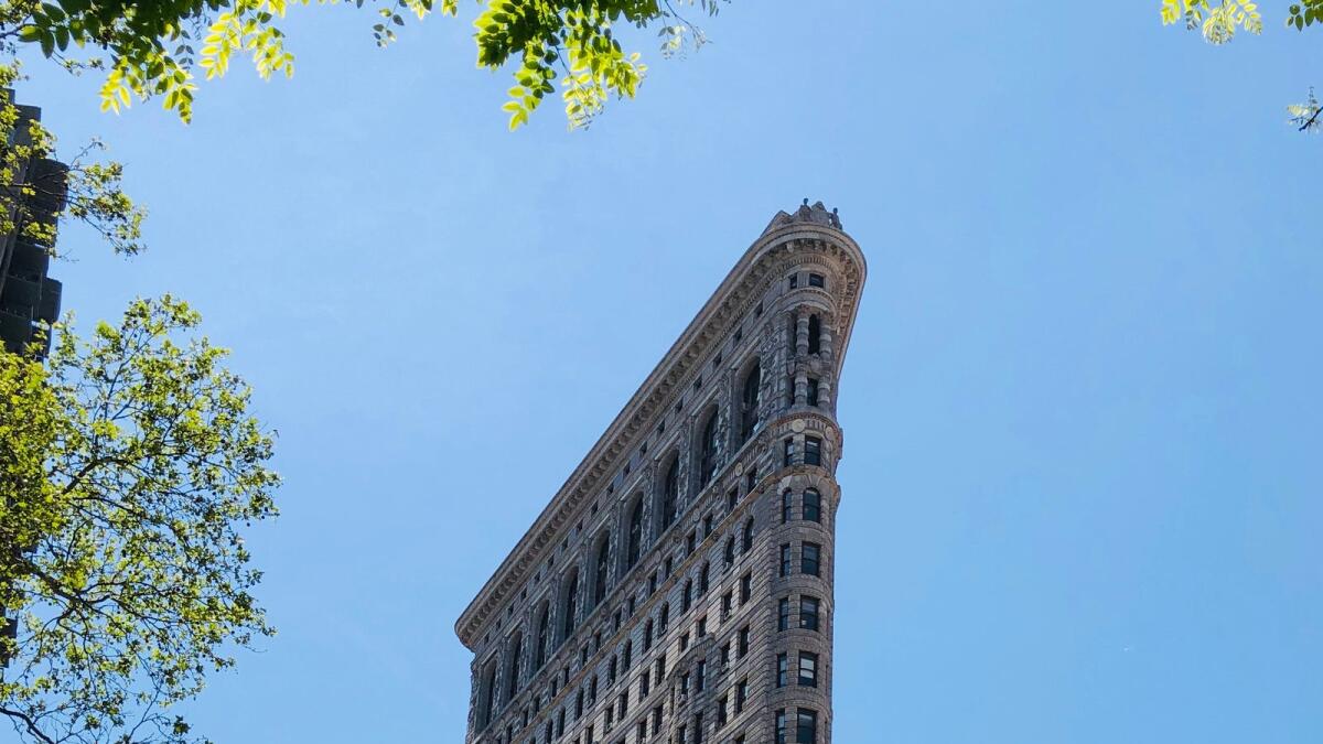 People walk past the Flatiron Building in New York City. - AFP