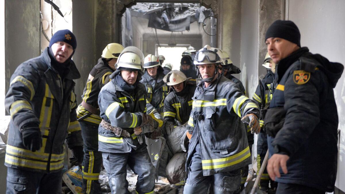 Emergencies personnel carry the body out of the damaged local city hall of Kharkiv on March 1, 2022, destroyed as a result of Russian troop shelling. (Photo: AFP)
