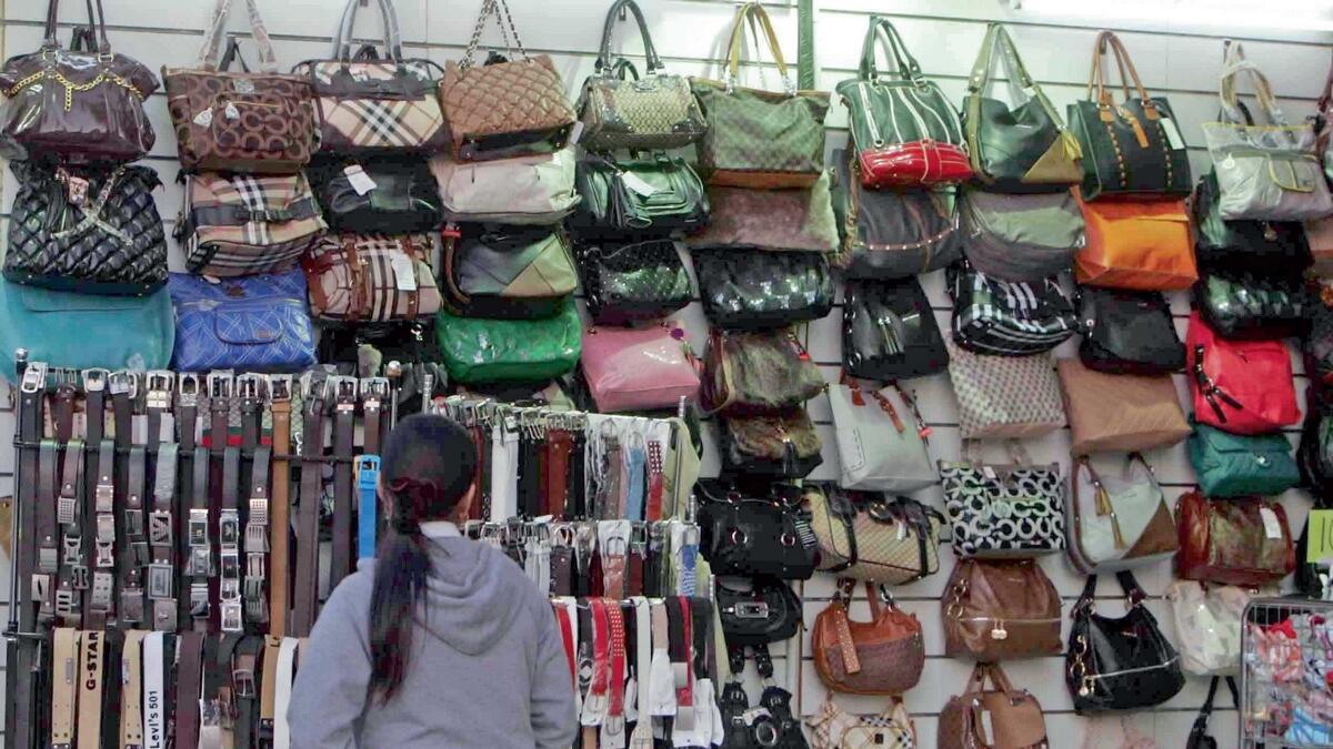 In spite of the law banning the sale of fake goods, replica designer bags, sunglasses, belts, wallets, shoes and more have a thriving market in the country. — KT file photo
