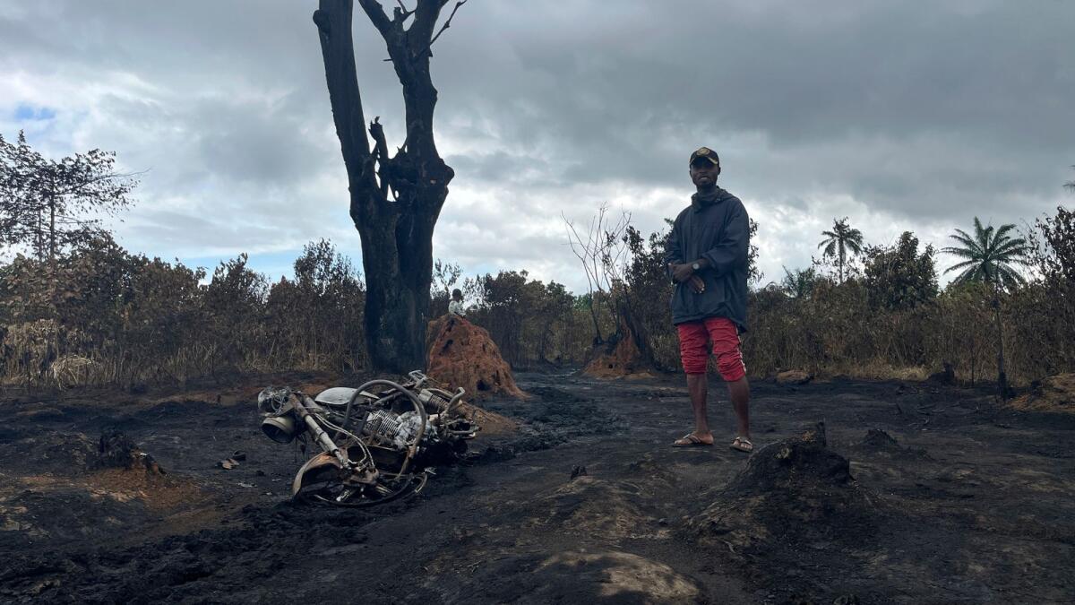 A man stands at the site of an illegal refinery explosion in Emohua, Niger Delta Nigeria, on Tuesday, October 3. — AP