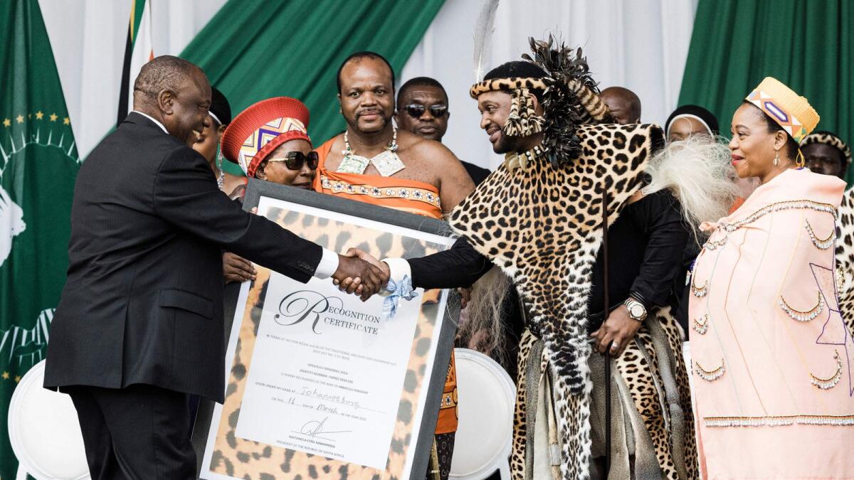 King Misuzulu Zulu, 48, receives the certifcate of recognition from South African President Cyiril Ramaphosa during the king's coronation at the Moses Mabhida Stadium in Durban on Saturday. — AFP