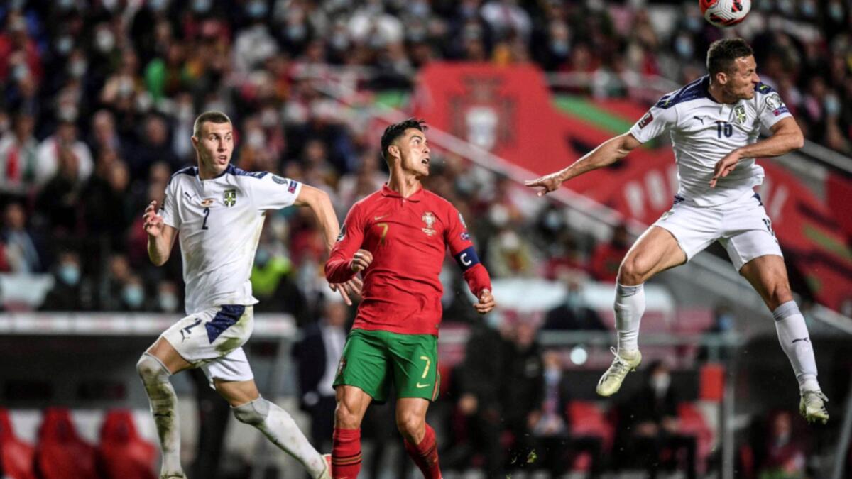 Serbia's defender Uros Spajic (R) heads the ball next to Portugal's forward Cristiano Ronaldo (C) and Serbia's defender Strahinja Pavlovic (L) during the FIFA World Cup  2022 qualification group A football match. — AFP
