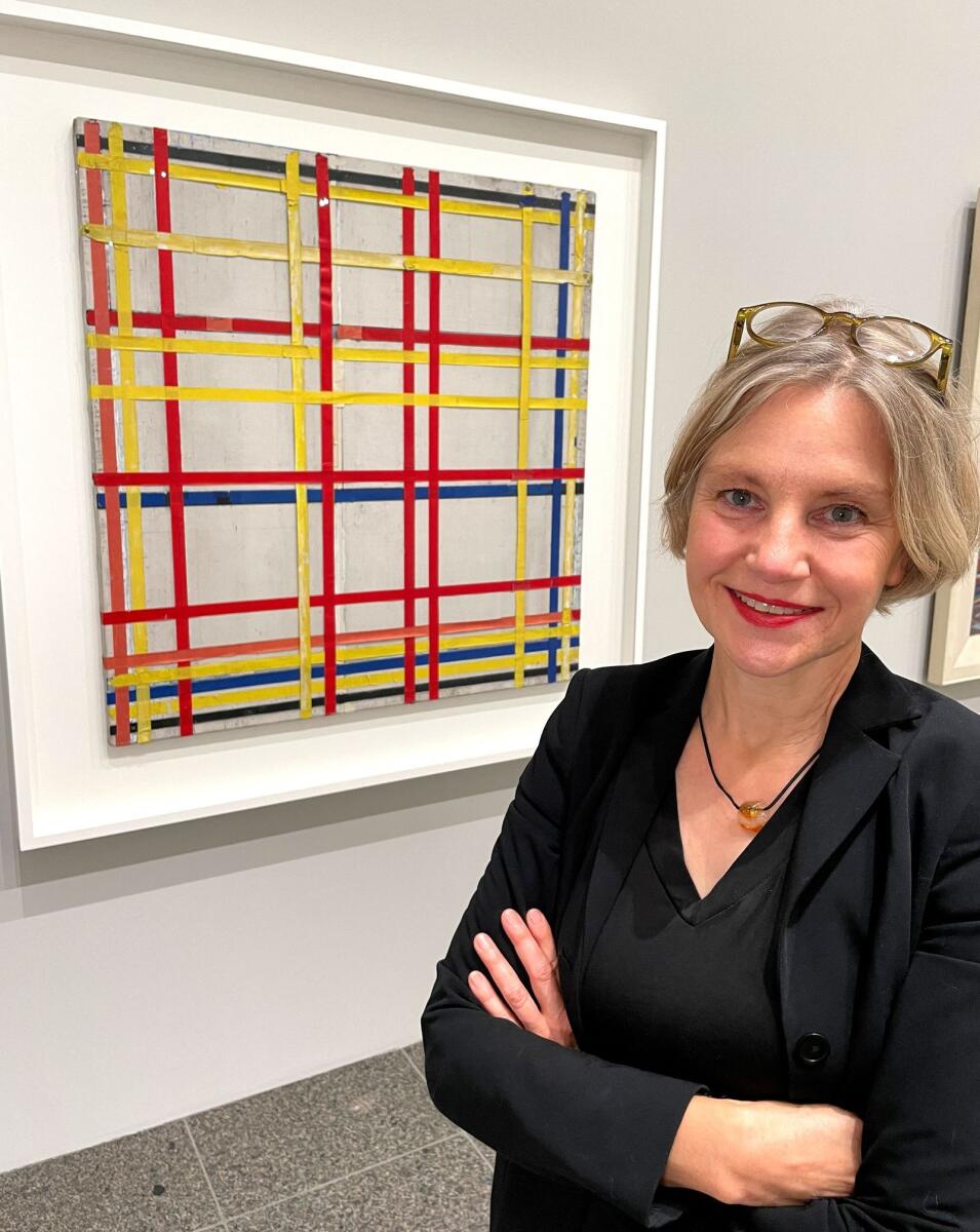 Curator Susanne Meyer-Bueser poses in front of the Piet Mondrian painting 'New York City I' in the Kunstsammlung NRW after it has been hanging upside down for 77 years in Duesseldorf, Germany, on Friday. — Reuters