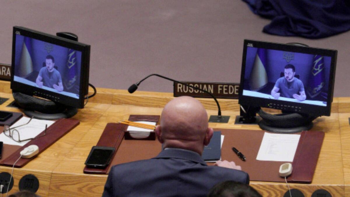 Russia's United Nations Ambassador Vasily Nebenzya listens as Ukraine President Volodymyr Zelensky addresses the United Nations Security Council by video. — AP