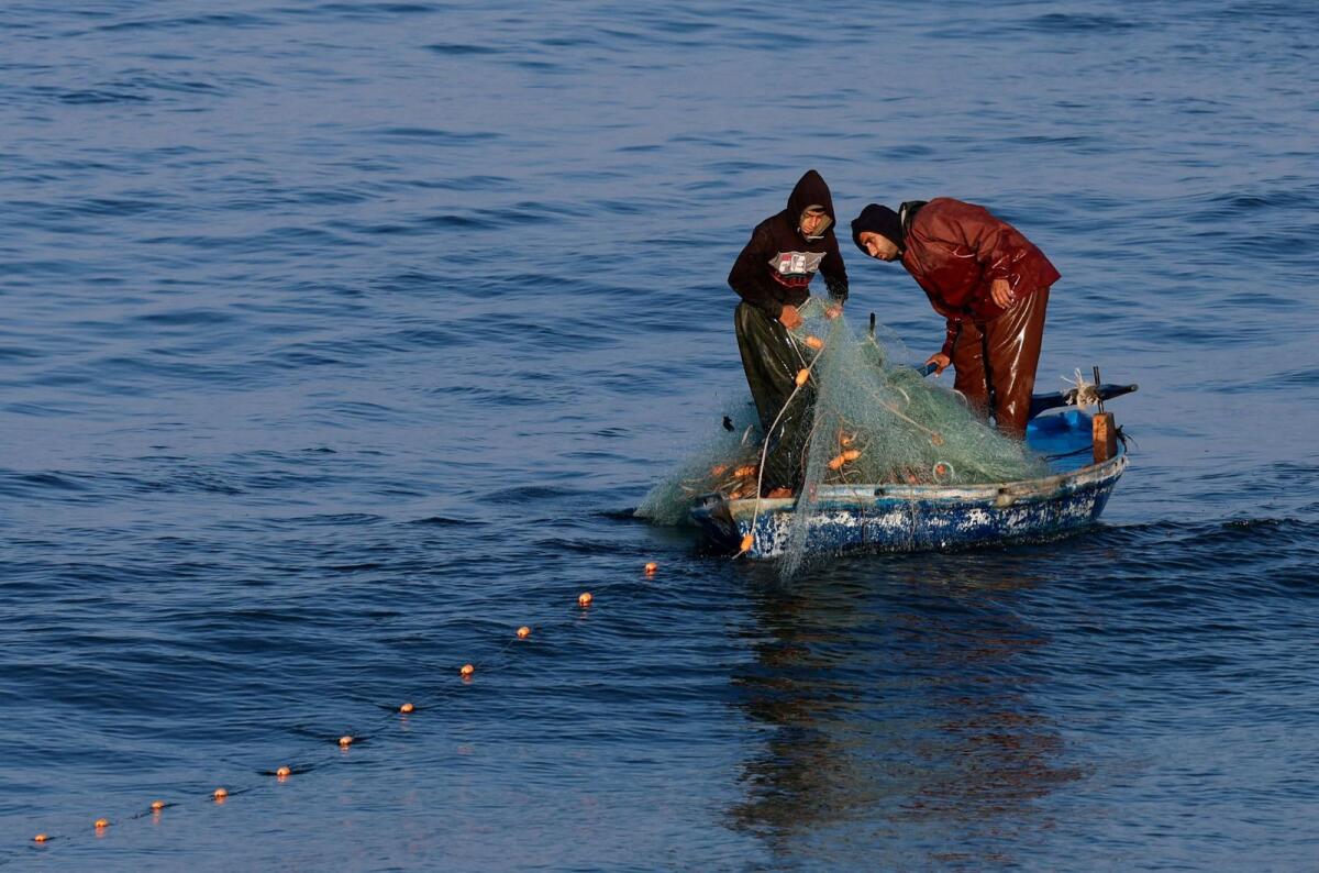 Palestinian fishermen work in Rafah in the southern Gaza Strip, on January 16. — Reuters