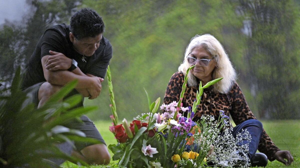 Raul Maradona (left) and Claudia Maradona, brother and sister of Diego Maradona, visit his grave on the first anniversary of his death in Bella Vista, Buenos Aires on Thursday. — Images: AP/AFP/Reuters