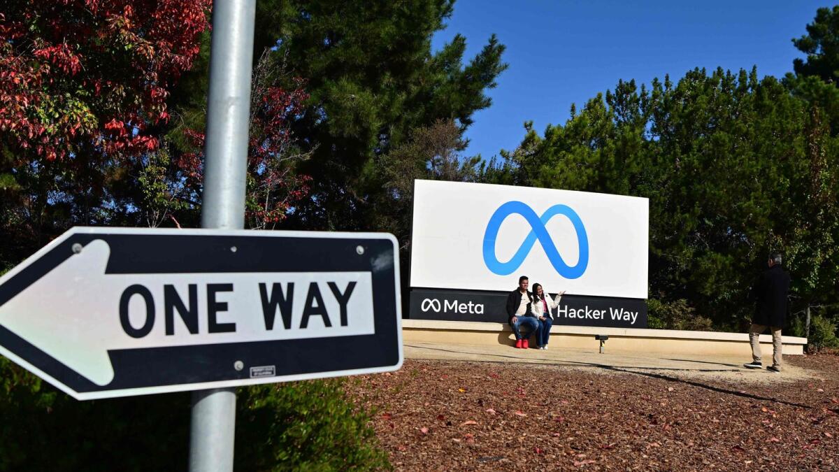 People take a photo at Meta (formerly Facebook) corporate headquarters in Menlo Park, California. - AFP file