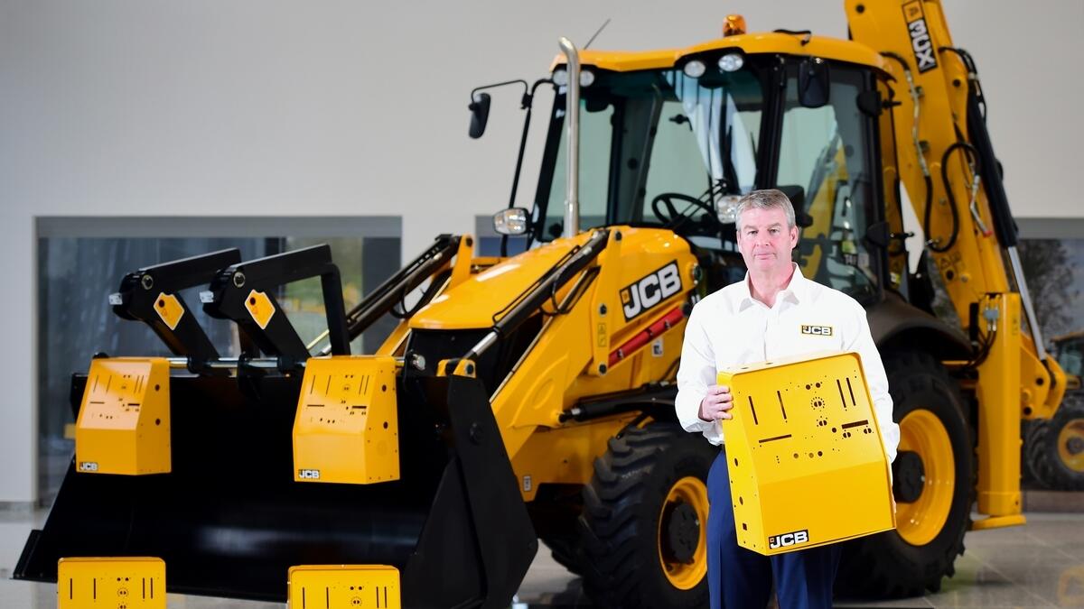 ANSWERING THE CALL: JCB chief innovation and growth officer Tim Burnhope with the ventilator housing prototypes