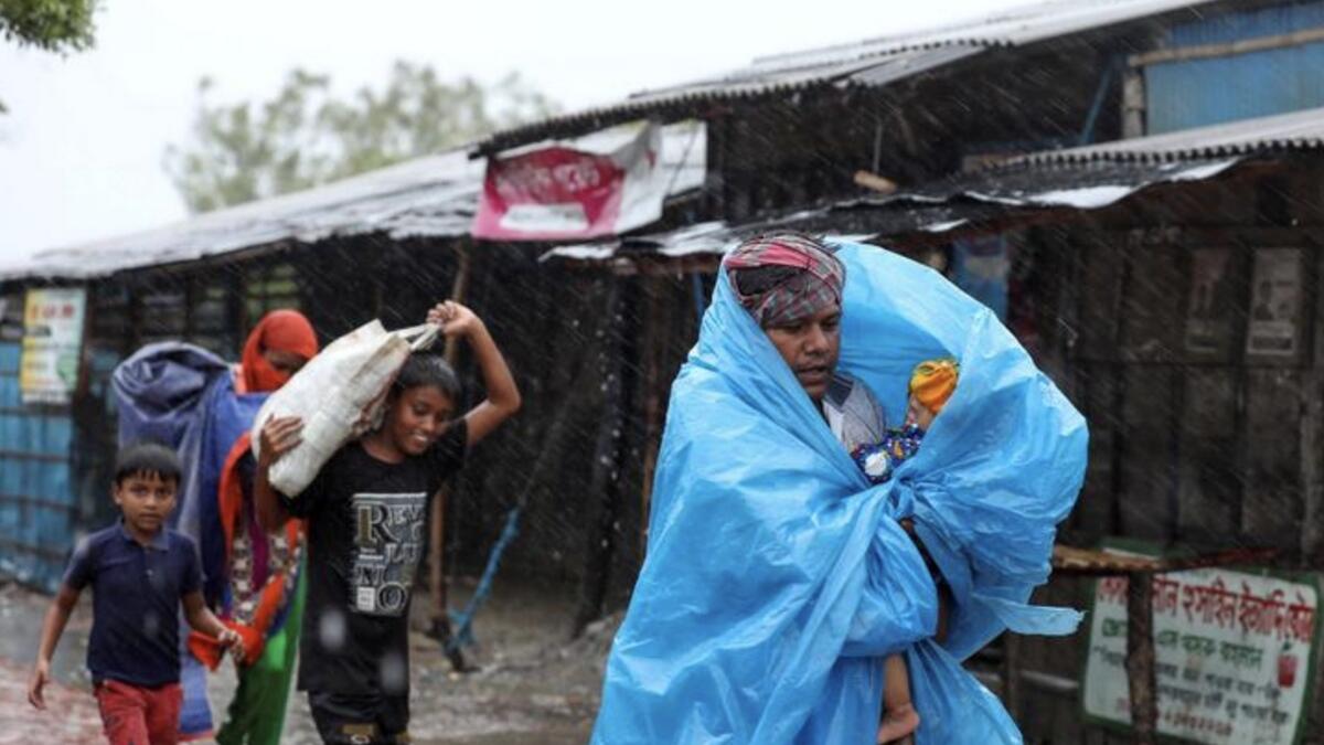 People make their way to a safer place before Cyclone Amphan makes its landfall in Gabura, on the outskirts of Satkhira district, Bangladesh, May 20. REUTERS/Stringer