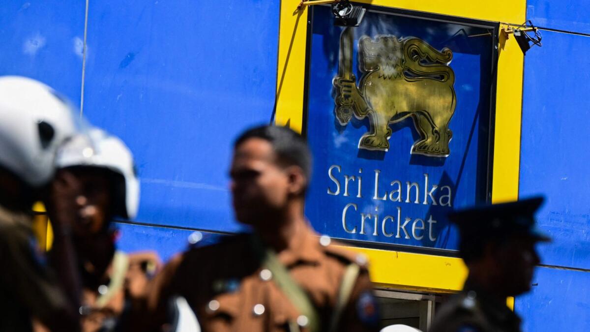 Police personnel stand guard outside Sri Lanka Cricket office n Colombo. — AFP file