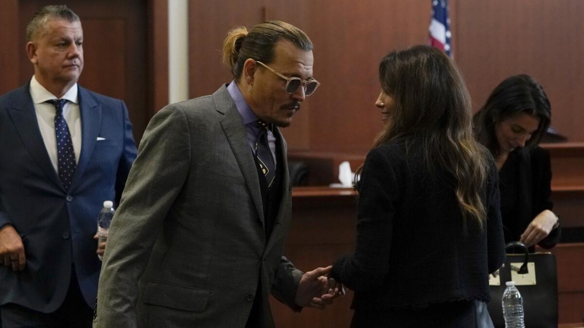 Actor Johnny Depp greets his legal team. Photo: AFP