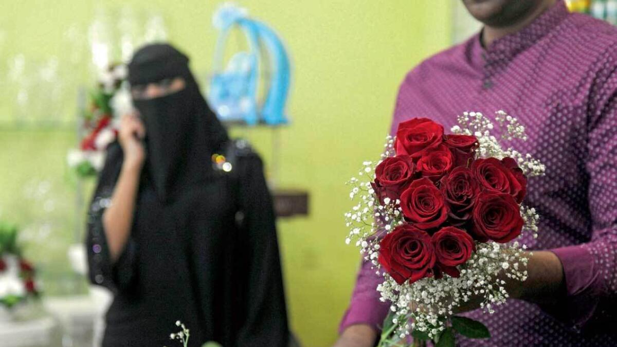 A florist prepares a Valentine’s Day bouquet for a client at a flower shop in Jeddah. — AFP