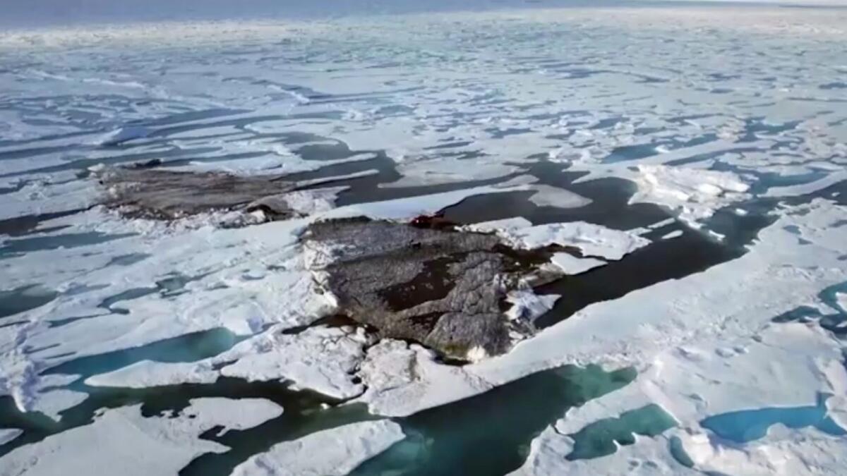 An aerial view of a tiny island off the coast of Greenland revealed by shifting pack ice. Photo: Reuters