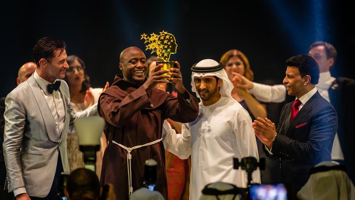 Sheikh Hamdan presenting the Global Teacher Prize trophy to Peter Tabichi.-Photo by Neeraj Murali
